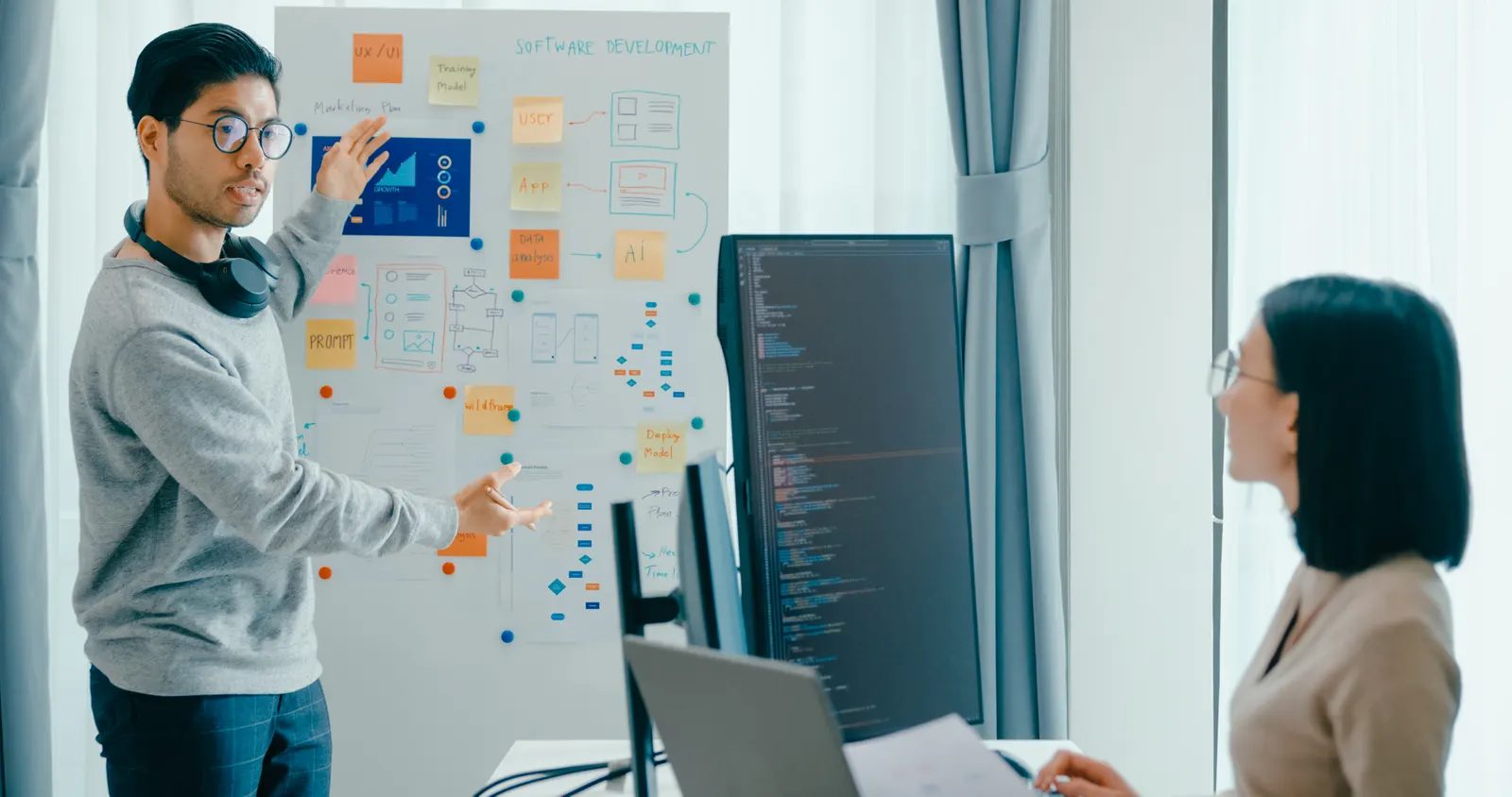 Consultant walking through a documented software development plan before build begins