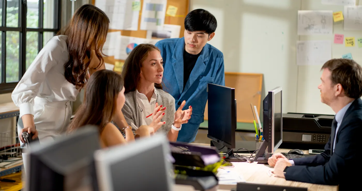 Team reviewing a Zoho Creator application together at a workstation
